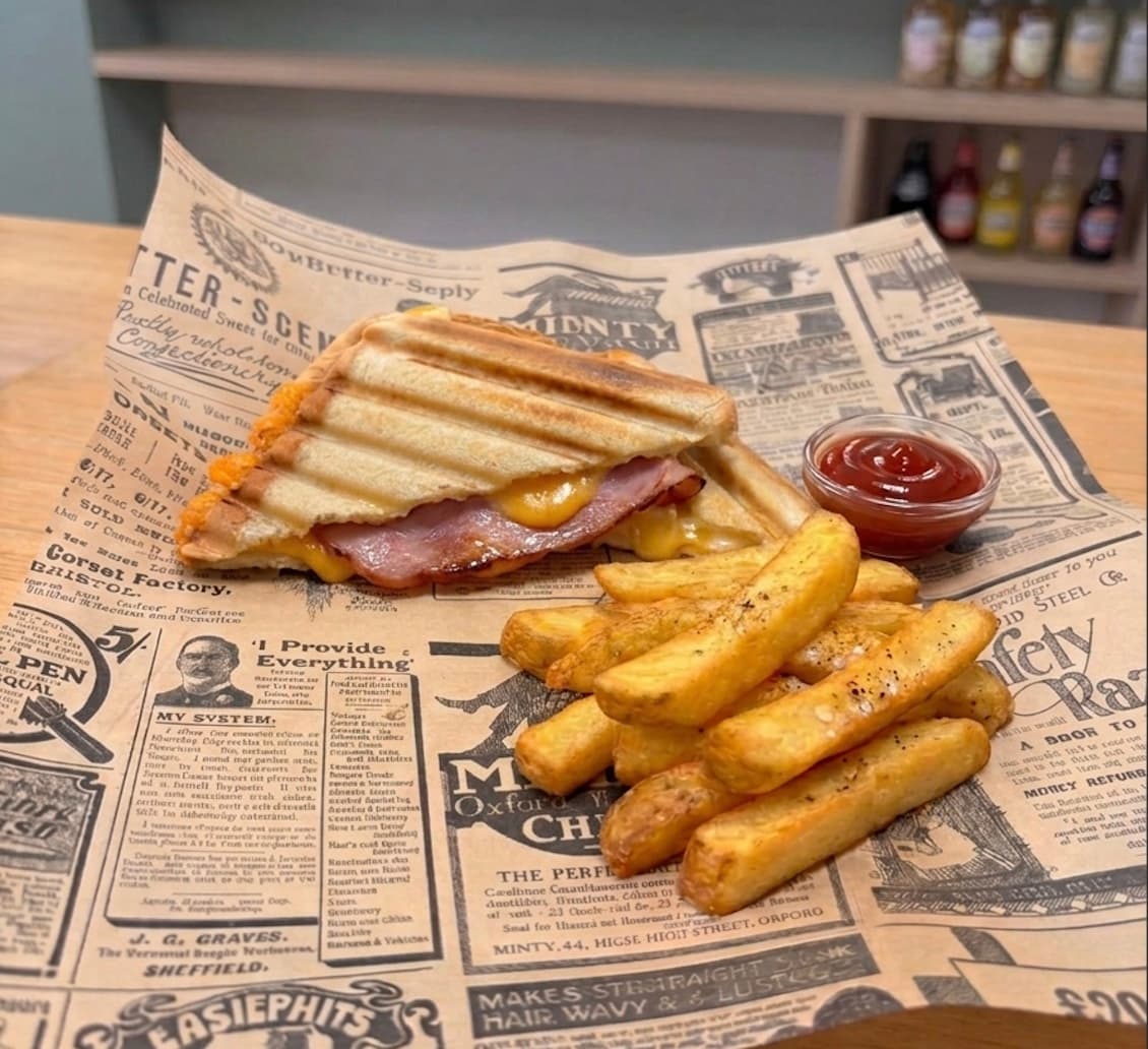 Toasted ham and cheese sandwich with chips at La Despensa